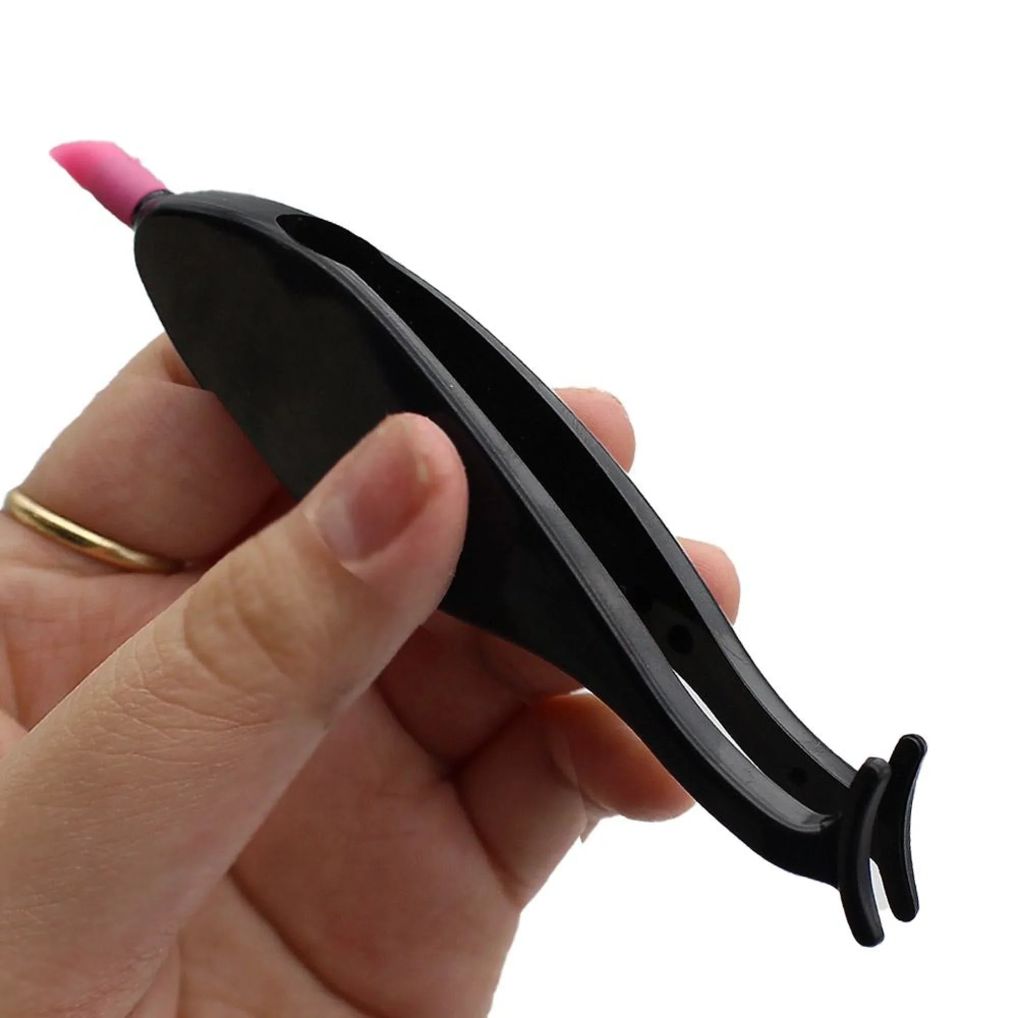 Black and pink tool held in a hand against a white background