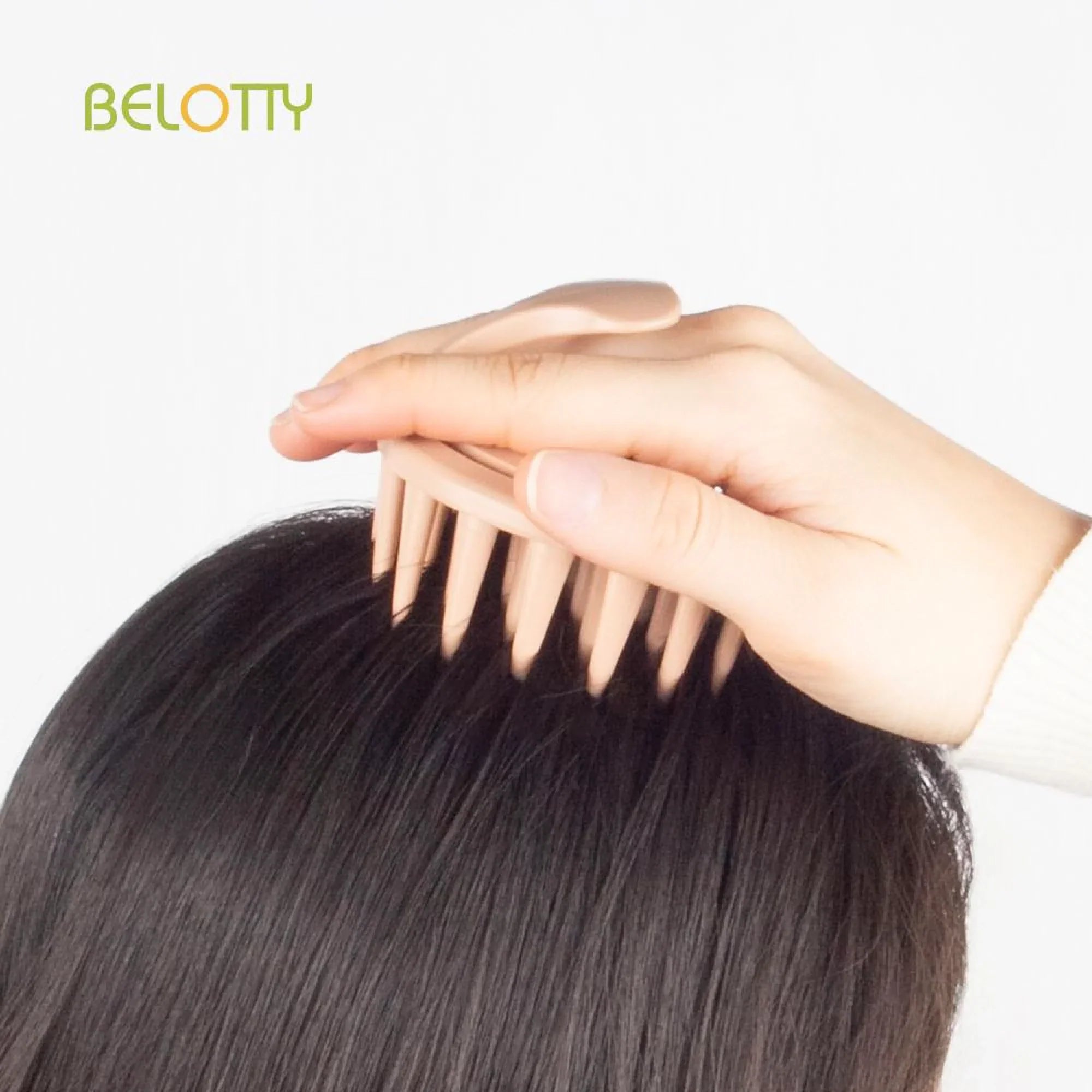 Hand combing through a hair extension with 'BELOTTY' branding.